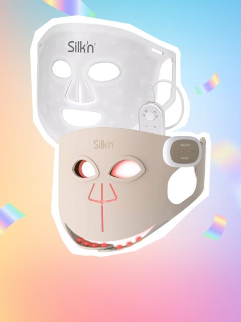 Silk'n face masks with lights and cute facial features against a rainbow-colored background.